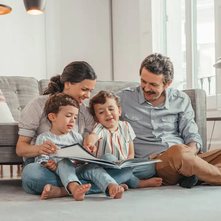 A family reading a book together at home